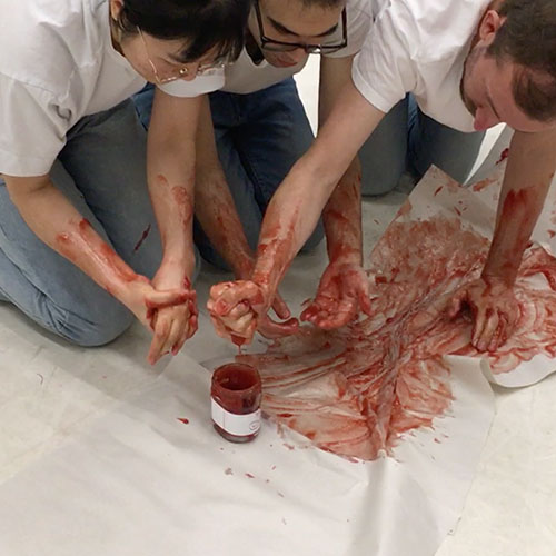 Factory workers are preparing the jam to be placed in a jar